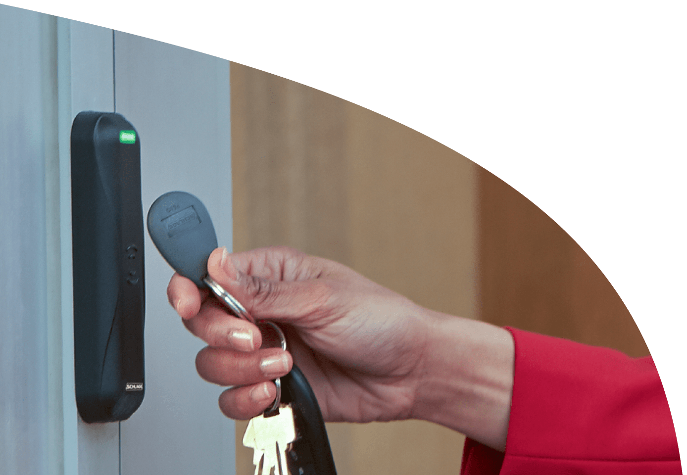 A person using a key-fob next to a sensor with a green light on it
