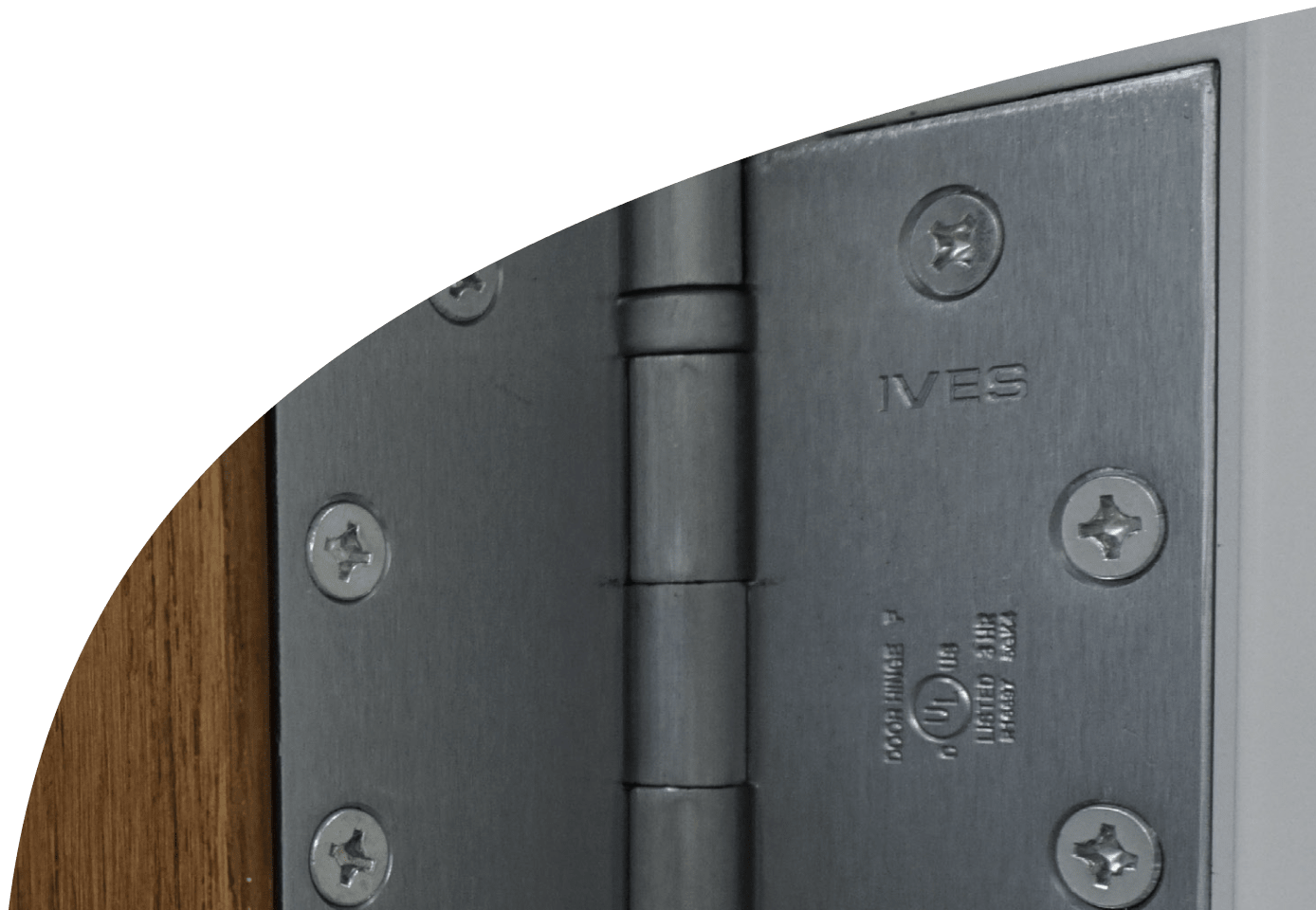 A close-up of an IVES brand door hinge