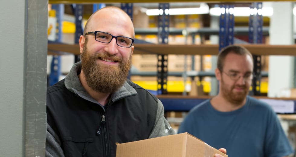 Two SECLOCK employees working in the warehouse