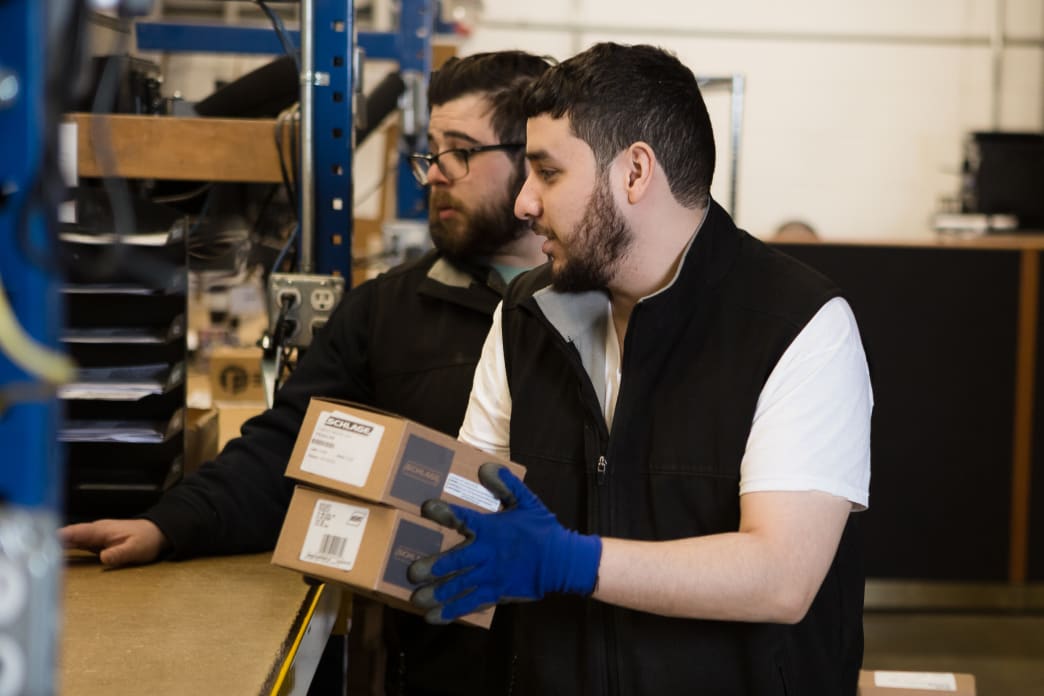 Two SECLOCK employees working in the warehouse